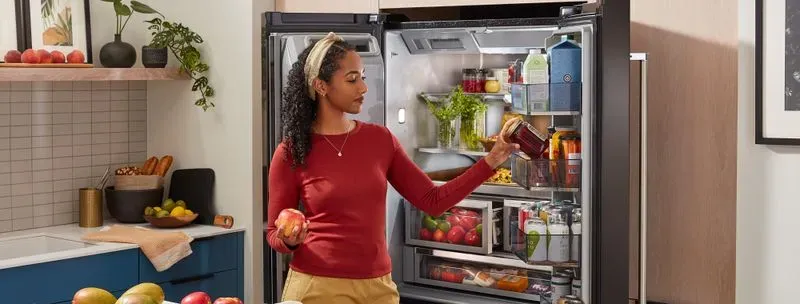 Lady infront of refrigerator